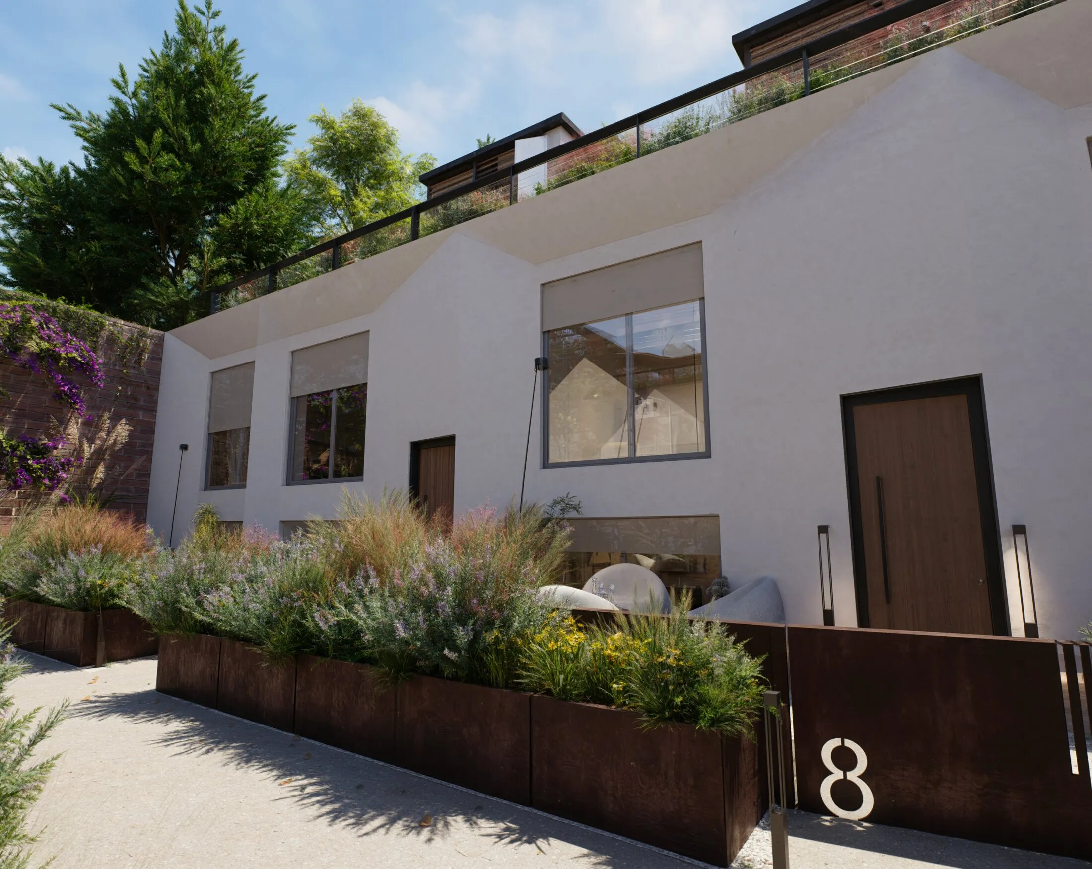 Le facciate a capanna delle townhouse con le fioriere in corten